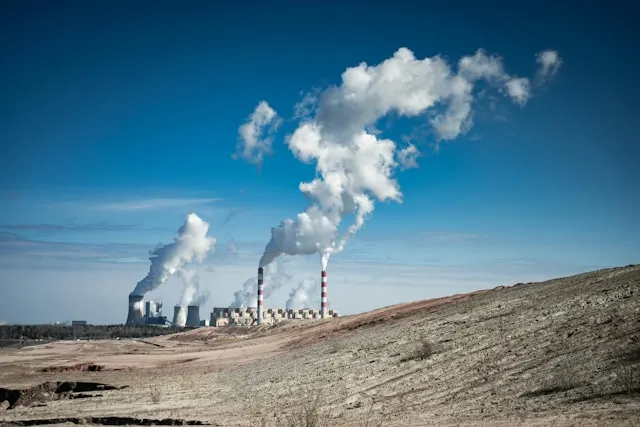 Power plant emitting steam into the sky, illustrating industrial emissions relevant to carbon credit systems and climate mitigation.