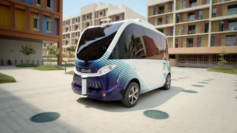 A Level 4 autonomous electric shuttle navigating a modern, shaded street in Masdar City, highlighting sustainable green transport solutions.